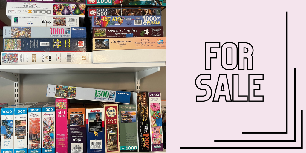 group of puzzles for sale sign